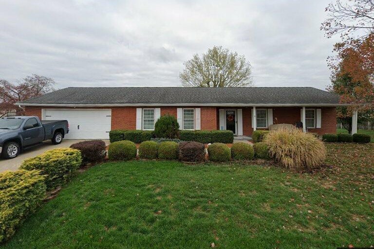 Exterior of 171 Township Road 1237, Proctorville, Ohio, a brick ranch home with a two-car garage, a covered front porch and a landscaped front yard