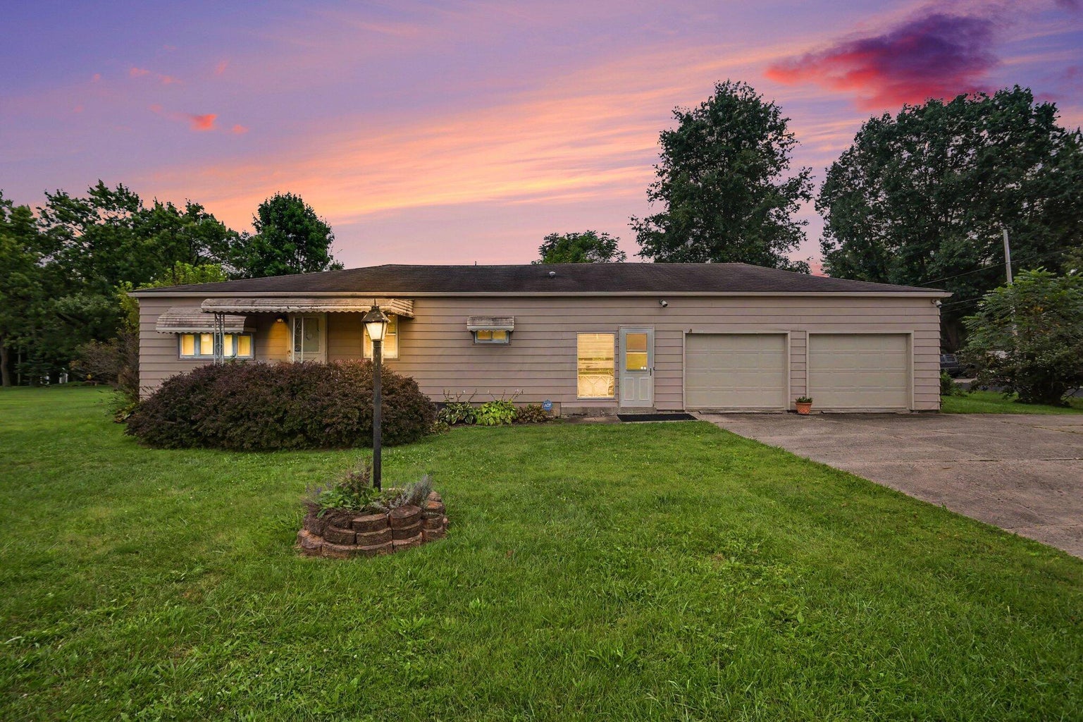 Exterior of 2336 W Fair Avenue, Lancaster, Ohio, a ranch home with attached two-car garage at sunset